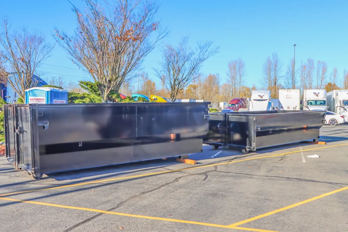 Professional dumpster rental service with roll-off container on residential driveway in North Canton